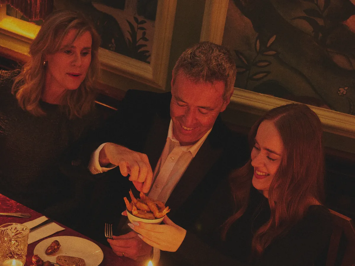 Friends sharing food by candlelight at Cosy Club