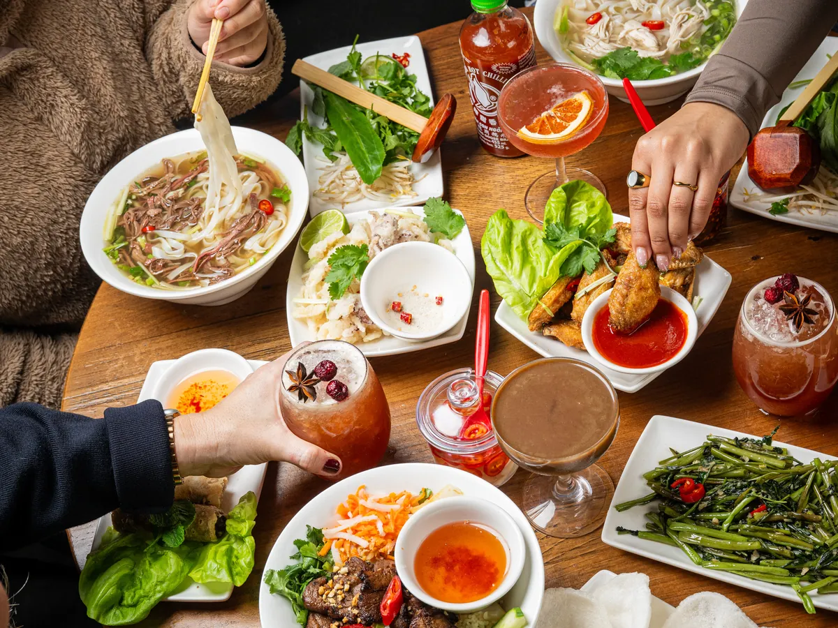 Bowls of pho and Vietnamese sharing plates at Pho
